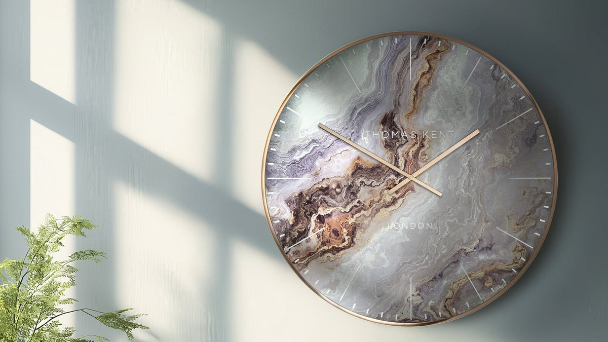 Oversized Oyster Bronze wall clock styled above a sofa
